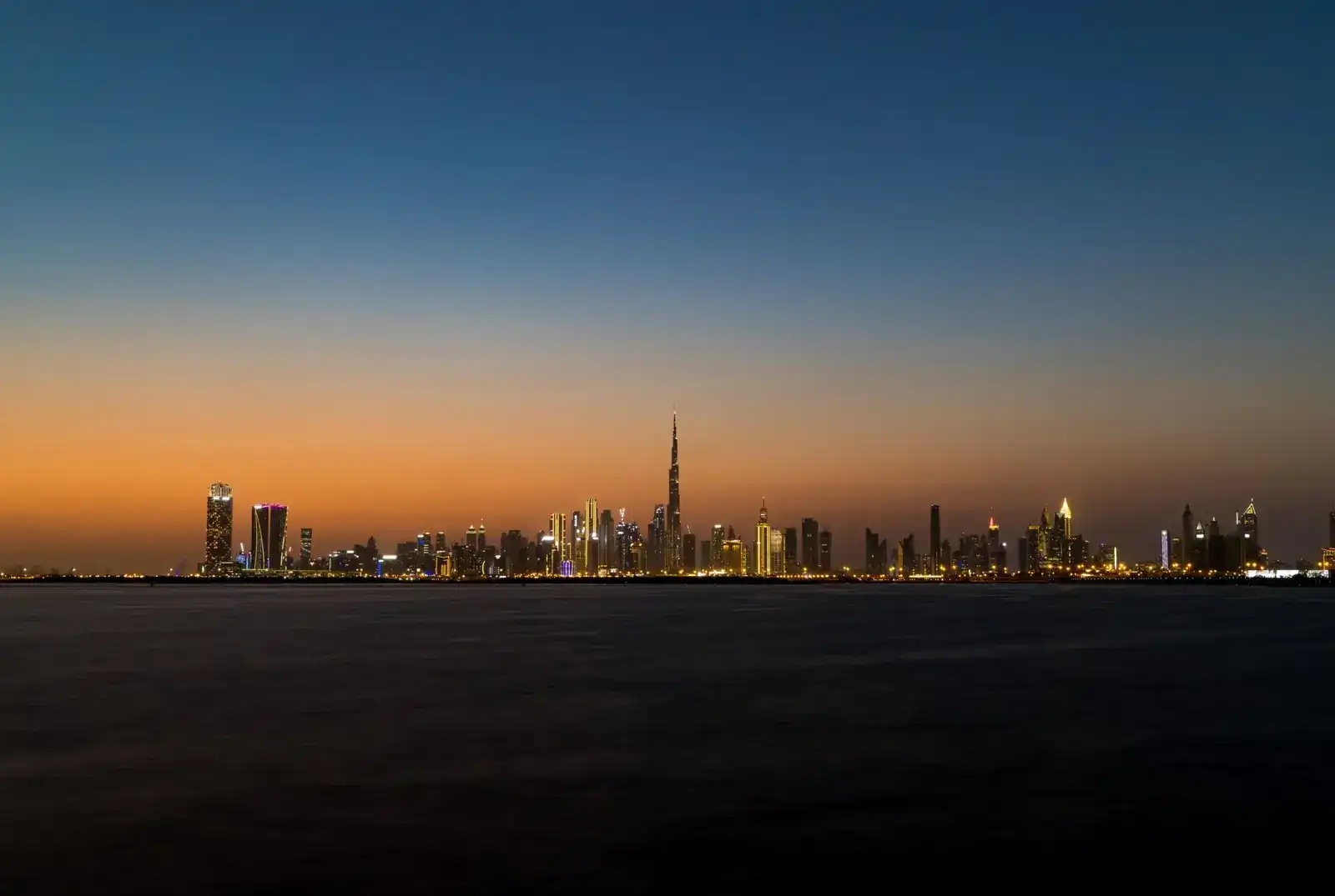 Dubai skyline across the water at dusk