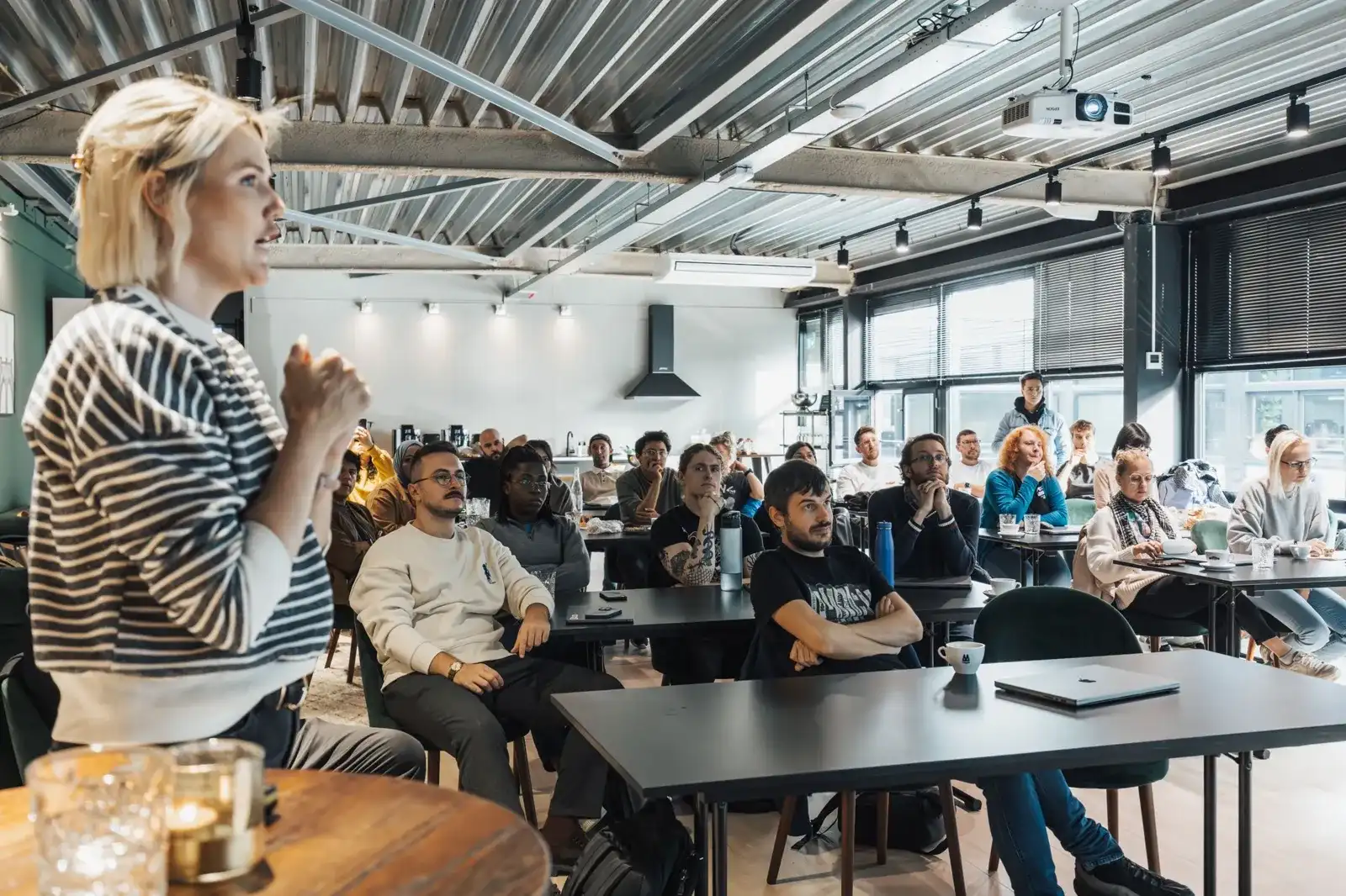 A speaker leading a workshop for a seated audience