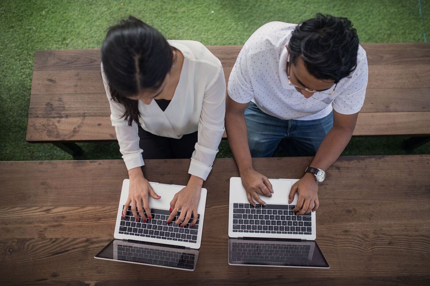 Founders working side by side on laptops in a shared workspace